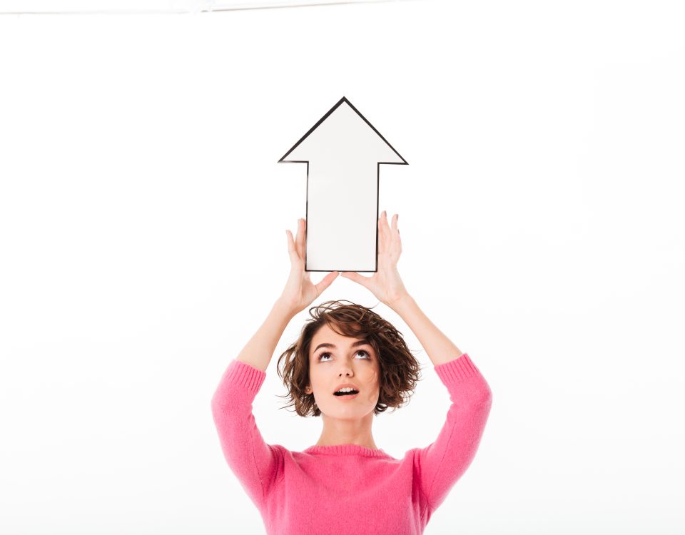 Woman holding an arrow pointing upwards
